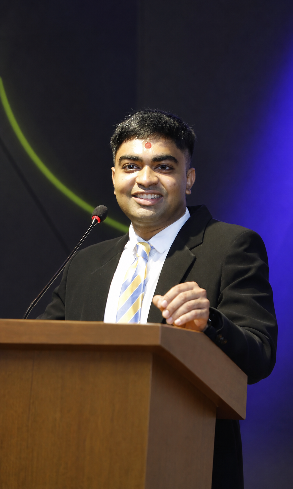 Om Dobariya speaking at a podium